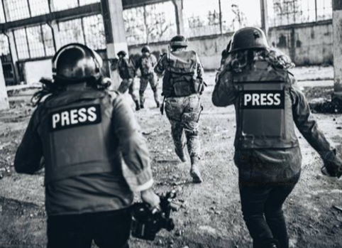 Journalists wearing press vests